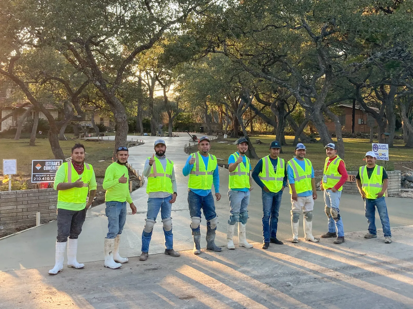 The Esteban's Concrete crew standing on a finished residential driveway in San Antonio