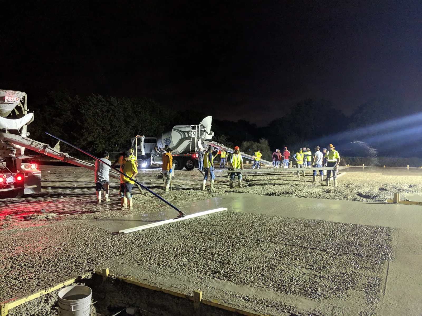Crew placing commercial concrete during a night pour
