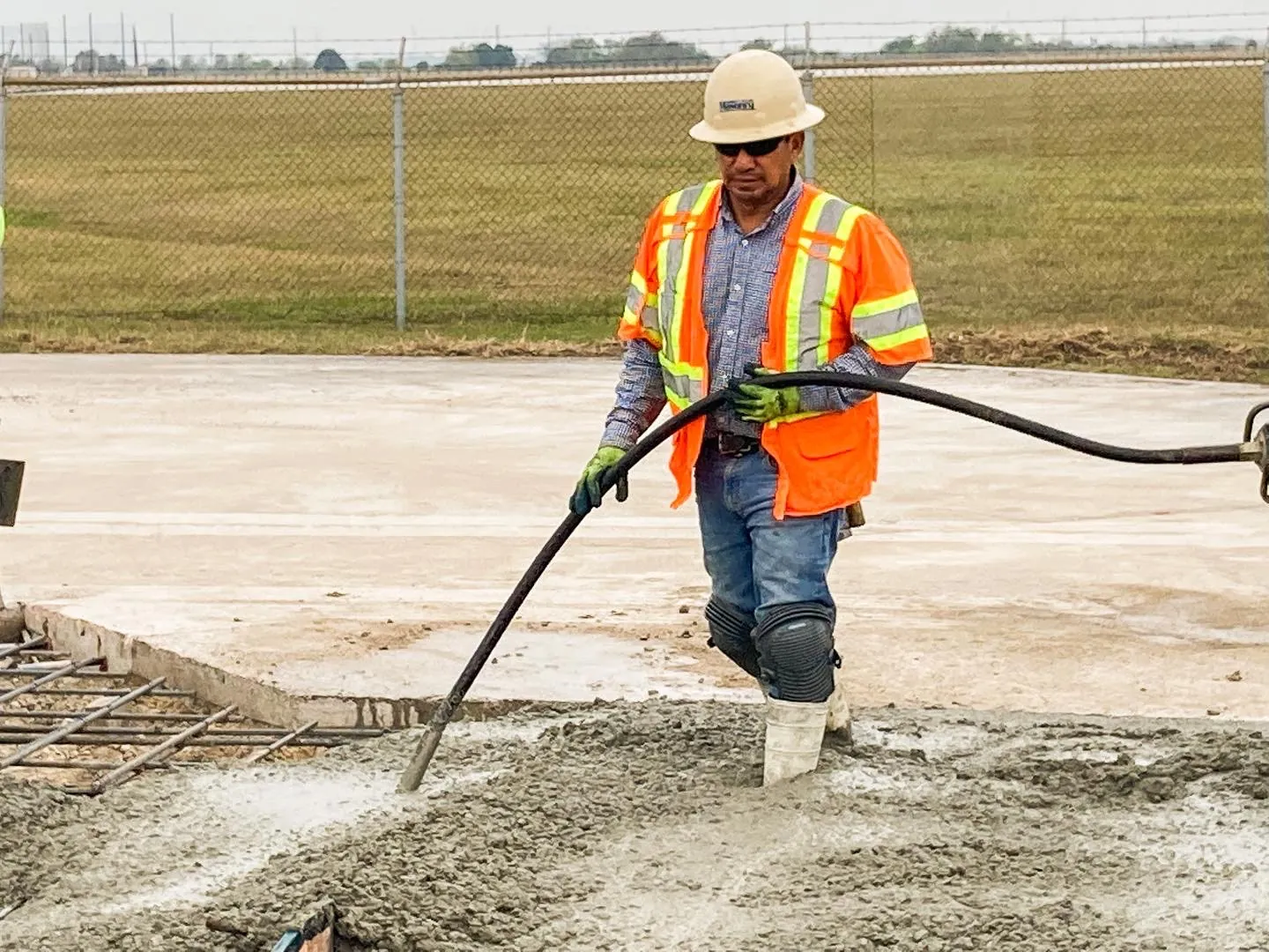 Concrete finisher screeding a fresh commercial slab