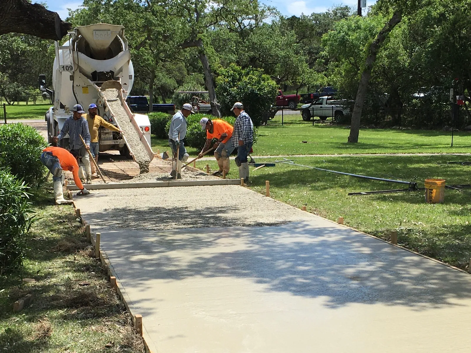Esteban's Concrete crew pouring and screeding a new sidewalk